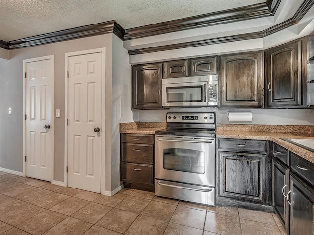 503 W Owens St, El Reno, OK 73036 - kitchen featuring stainless steel appliances, crown molding, dark brown cabinetry, a textured ceiling, and light tile patterned floors