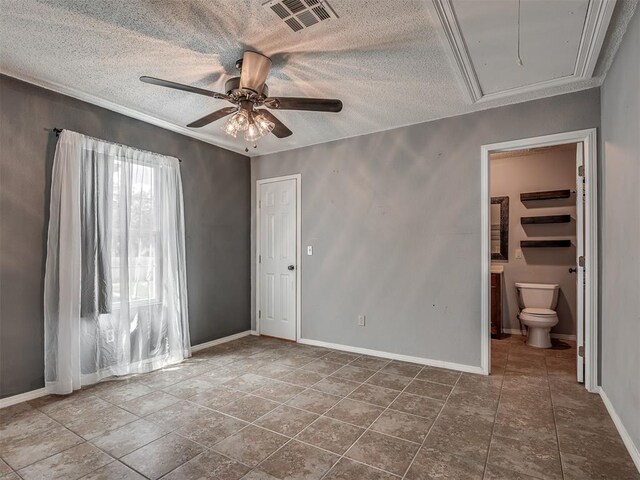 503 W Owens St, El Reno, OK 73036 - unfurnished bedroom featuring attic access, connected bathroom, a ceiling fan, a textured ceiling, and crown molding