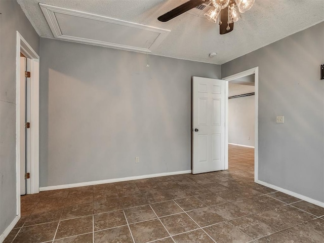 503 W Owens St, El Reno, OK 73036 - unfurnished room with attic access, a ceiling fan, and a textured ceiling