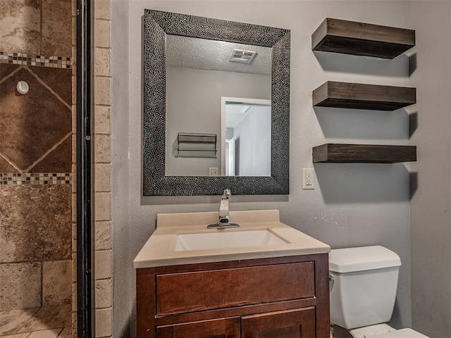 503 W Owens St, El Reno, OK 73036 - bathroom featuring vanity, a shower stall, and a textured ceiling