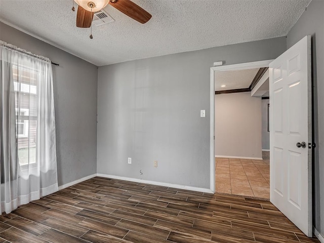 503 W Owens St, El Reno, OK 73036 - spare room with wood tiled floors, a ceiling fan, and a textured ceiling