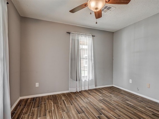 503 W Owens St, El Reno, OK 73036 - spare room featuring ceiling fan, wood tiled floors, and a textured ceiling