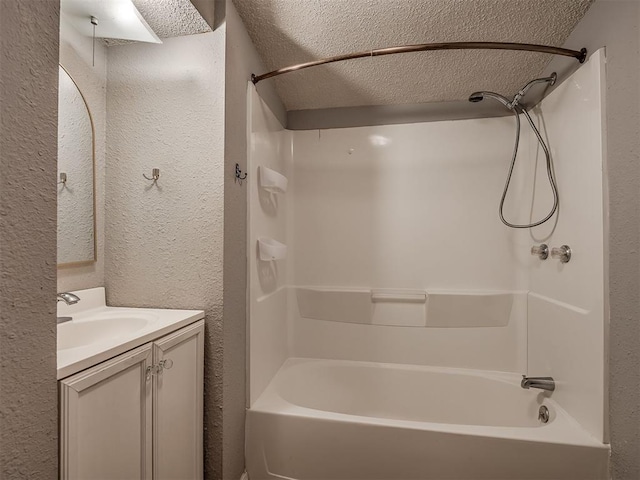 503 W Owens St, El Reno, OK 73036 - bathroom featuring a textured wall, a textured ceiling, bathtub / shower combination, and vanity