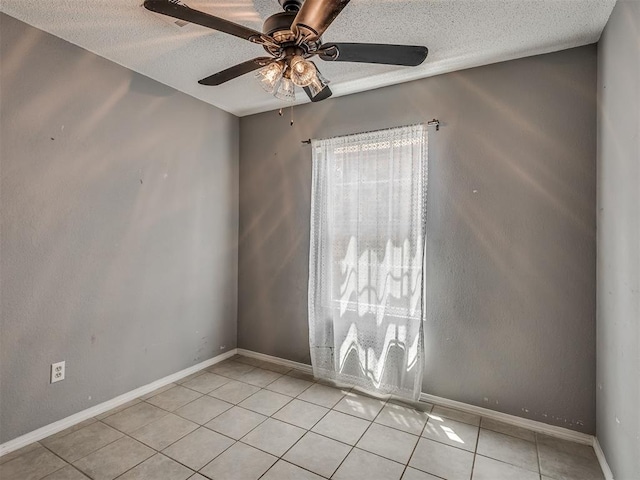503 W Owens St, El Reno, OK 73036 - empty room with a textured ceiling, light tile patterned floors, and ceiling fan