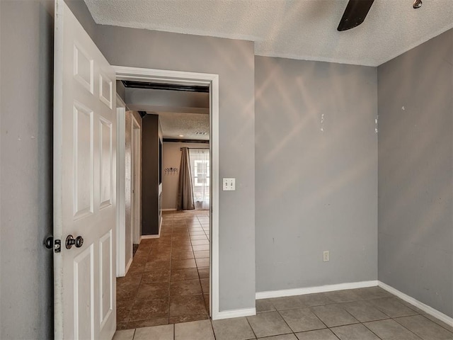 503 W Owens St, El Reno, OK 73036 - hallway featuring a textured ceiling and light tile patterned flooring