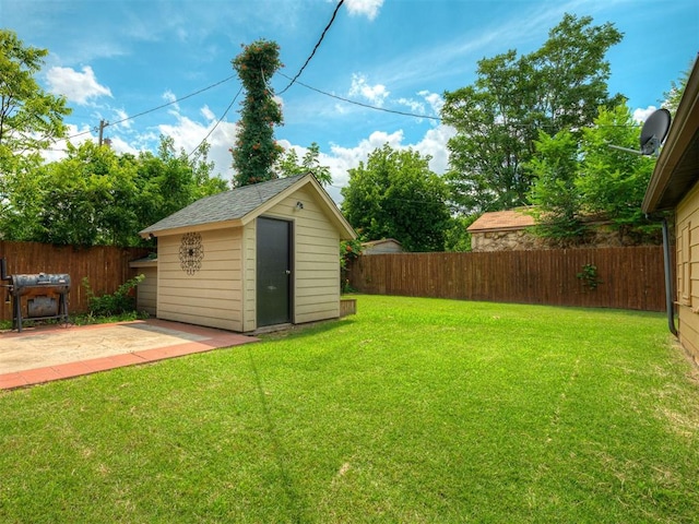 503 W Owens St, El Reno, OK 73036 - fenced backyard featuring a storage unit and a patio