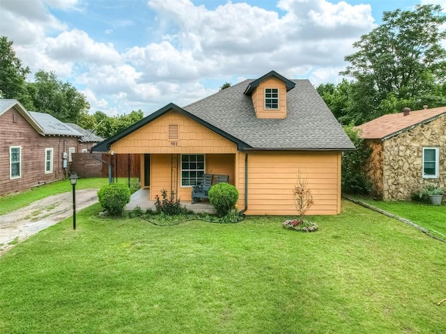 503 W Owens St, El Reno, OK 73036 - view of front of property with a shingled roof, a front lawn, and a porch