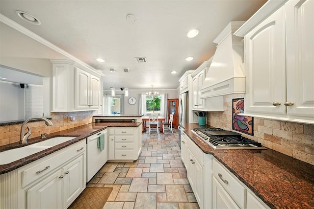 7617 N Ann Arbor Ave, Oklahoma City, OK 73132 - kitchen with stainless steel gas stovetop, custom range hood, a peninsula, white dishwasher, and light stone finish flooring