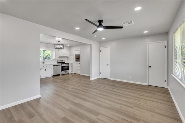 112 Asbill Ave, Yukon, OK 73099 - unfurnished living room with a ceiling fan, recessed lighting, light wood finished floors, and a chandelier