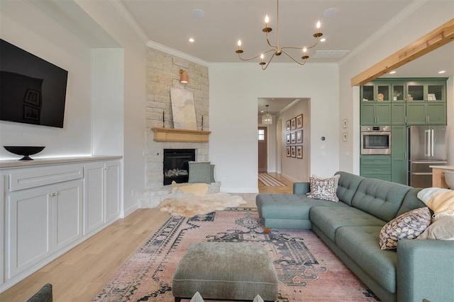 3824 Library Ln, Edmond, OK 73034 - living area featuring light wood-style floors, crown molding, a chandelier, and a stone fireplace