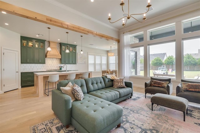 3824 Library Ln, Edmond, OK 73034 - living room with a chandelier, light wood-type flooring, crown molding, and recessed lighting