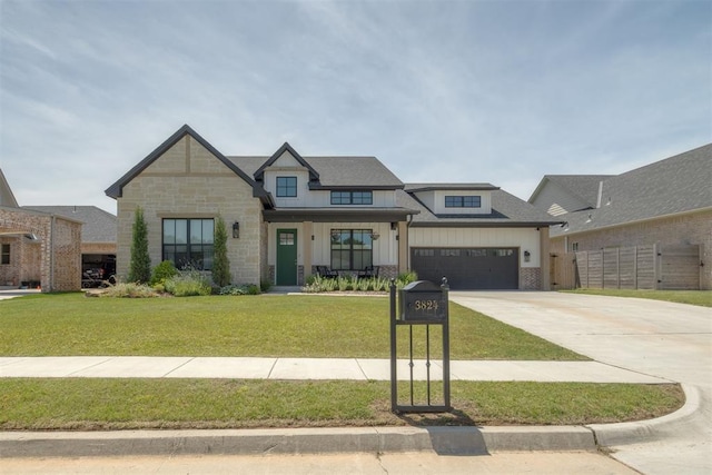 3824 Library Ln, Edmond, OK 73034 - view of front of property featuring driveway, board and batten siding, stone siding, a garage, and a porch