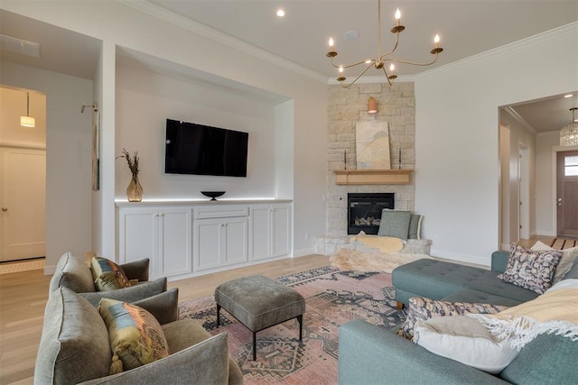 3824 Library Ln, Edmond, OK 73034 - living area with crown molding, light wood-style flooring, a chandelier, and a stone fireplace
