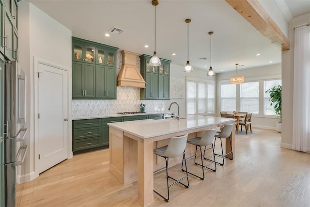 3824 Library Ln, Edmond, OK 73034 - kitchen with green cabinetry, premium range hood, light wood finished floors, and recessed lighting