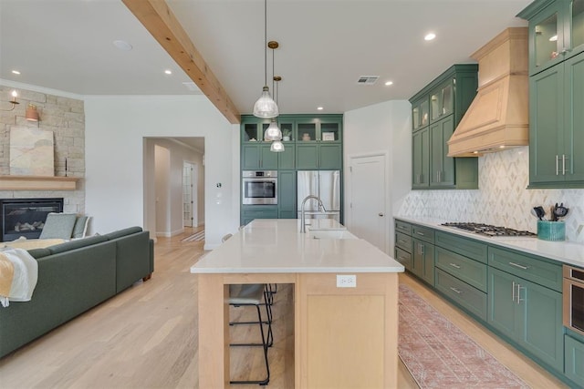 3824 Library Ln, Edmond, OK 73034 - kitchen featuring green cabinets, light countertops, open floor plan, crown molding, and recessed lighting