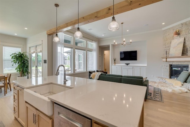 3824 Library Ln, Edmond, OK 73034 - kitchen with open floor plan, light wood finished floors, crown molding, an island with sink, and dishwasher