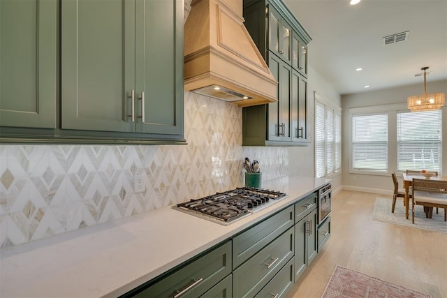 3824 Library Ln, Edmond, OK 73034 - kitchen featuring green cabinetry, premium range hood, stainless steel gas stovetop, light countertops, and recessed lighting