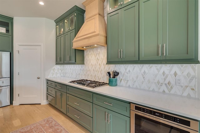 3824 Library Ln, Edmond, OK 73034 - kitchen featuring green cabinets, custom exhaust hood, and appliances with stainless steel finishes