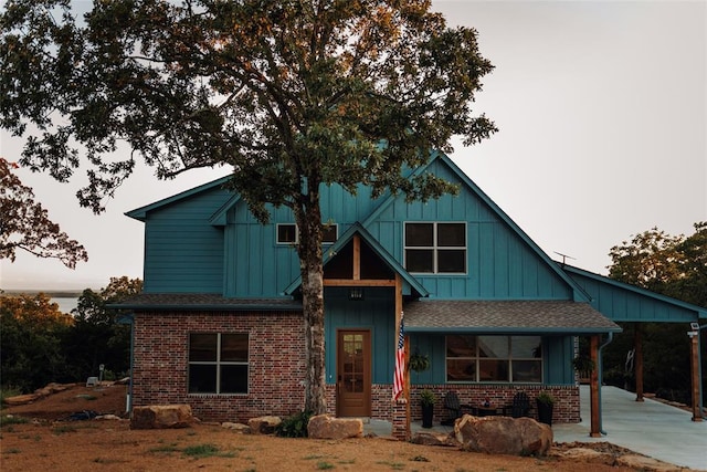 118900 S 4213th Rd, Eufaula, OK 74432 - view of front of house featuring brick siding, board and batten siding, a shingled roof, and driveway
