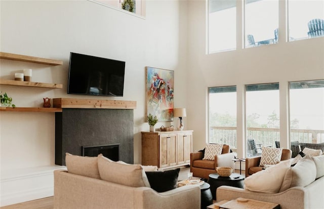 118900 S 4213th Rd, Eufaula, OK 74432 - living room with a towering ceiling, healthy amount of natural light, a fireplace, and wood finished floors