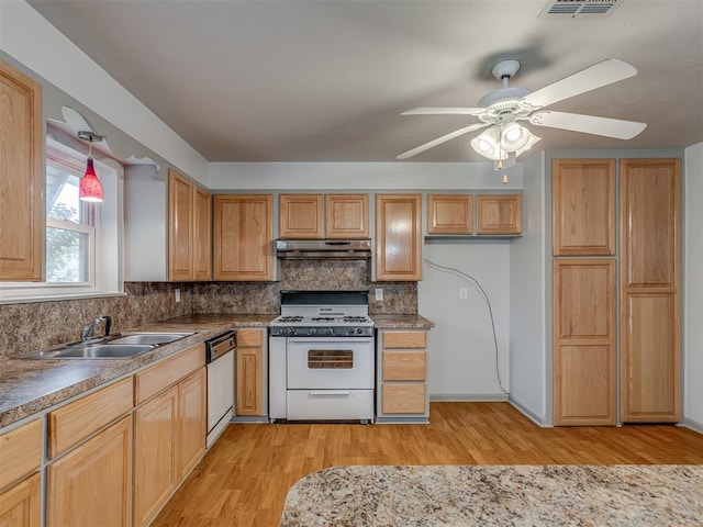 2822 N Market Ave, Shawnee, OK 74804 - kitchen with white appliances, under cabinet range hood, light wood-type flooring, and backsplash