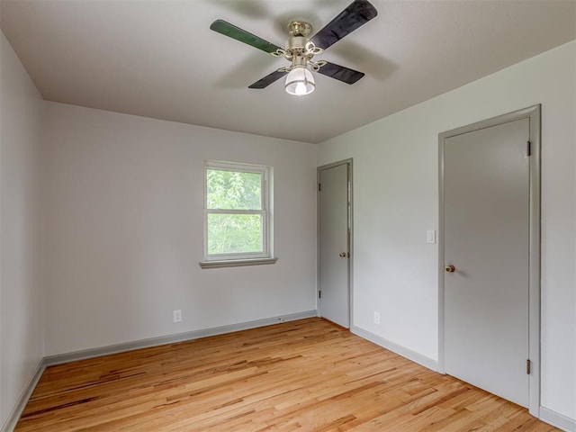 2822 N Market Ave, Shawnee, OK 74804 - unfurnished bedroom featuring light wood-style floors and a ceiling fan
