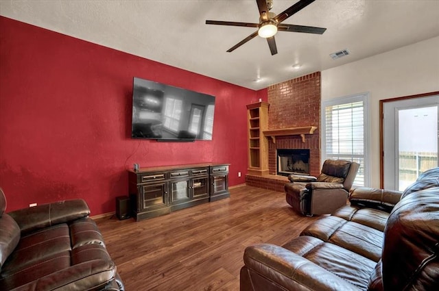 11517 Brighton Ct, Midwest City, OK 73130 - living room featuring a ceiling fan, wood finished floors, and a fireplace