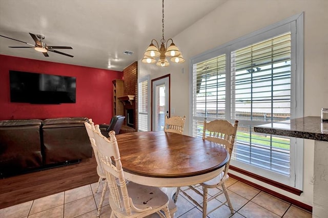 11517 Brighton Ct, Midwest City, OK 73130 - dining area featuring healthy amount of natural light, a chandelier, an accent wall, and light tile patterned floors