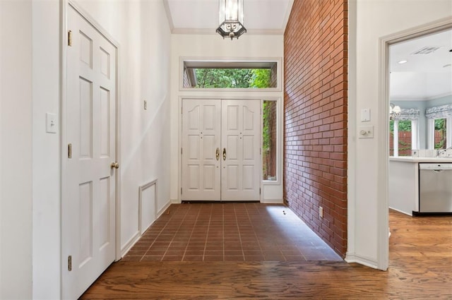 2825 NW Grand Blvd Unit 3, Oklahoma City, OK 73116 - foyer entrance with brick wall and crown molding