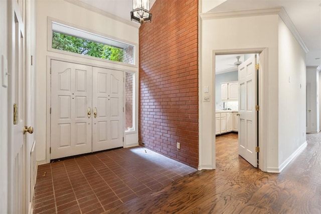 2825 NW Grand Blvd Unit 3, Oklahoma City, OK 73116 - entryway with ornamental molding, brick wall, and ceiling fan