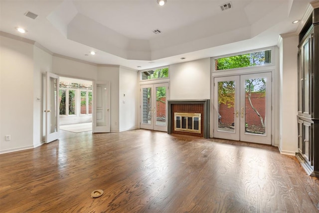 2825 NW Grand Blvd Unit 3, Oklahoma City, OK 73116 - unfurnished living room featuring french doors, a raised ceiling, wood finished floors, and recessed lighting