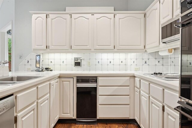 2825 NW Grand Blvd Unit 3, Oklahoma City, OK 73116 - kitchen with dishwasher, tasteful backsplash, white cabinets, and electric cooktop