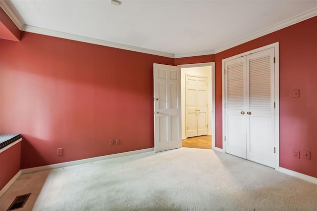 2825 NW Grand Blvd Unit 3, Oklahoma City, OK 73116 - unfurnished bedroom featuring carpet, crown molding, and a closet