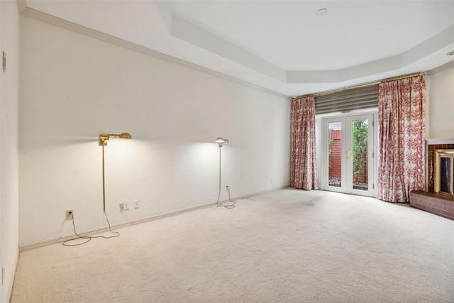 2825 NW Grand Blvd Unit 3, Oklahoma City, OK 73116 - unfurnished living room featuring a tray ceiling and carpet flooring