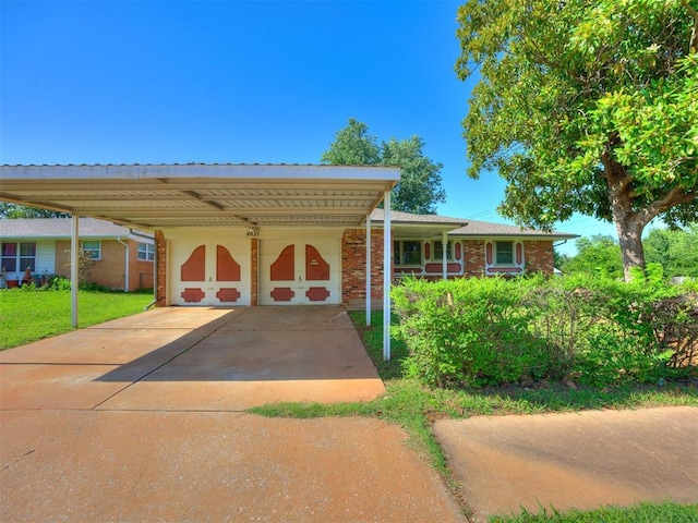4021 E Larkwood Dr, Del City, OK 73115 - view of front of house featuring brick siding, a front yard, driveway, and an attached garage