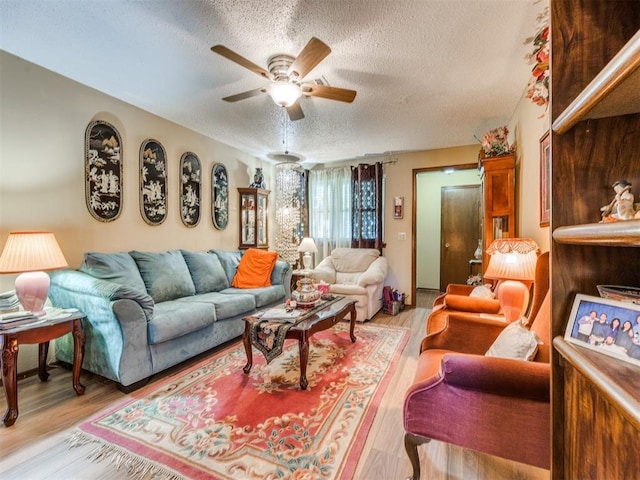 4021 E Larkwood Dr, Del City, OK 73115 - living room with a textured ceiling, a ceiling fan, and light wood-style flooring