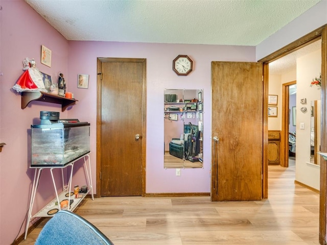 4021 E Larkwood Dr, Del City, OK 73115 - bedroom featuring wood finished floors and a textured ceiling