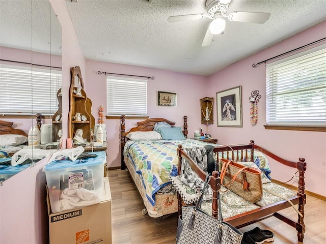4021 E Larkwood Dr, Del City, OK 73115 - bedroom with wood finished floors, a textured ceiling, and ceiling fan