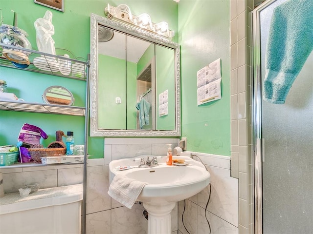 4021 E Larkwood Dr, Del City, OK 73115 - bathroom with tile walls, a stall shower, and a wainscoted wall