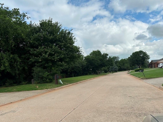 11413 Spring Creek Rd, Oklahoma City, OK 73162 - view of concrete road featuring curbs