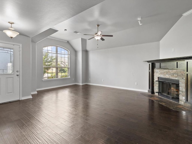3325 NW 161st St, Edmond, OK 73013 - unfurnished living room with vaulted ceiling, ceiling fan, wood finished floors, and a stone fireplace