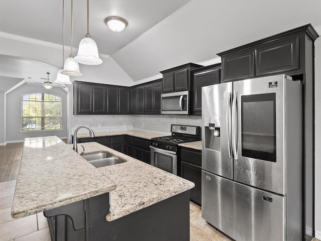 3325 NW 161st St, Edmond, OK 73013 - kitchen featuring stainless steel appliances, ceiling fan, dark cabinetry, vaulted ceiling, and light stone counters