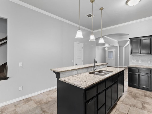 3325 NW 161st St, Edmond, OK 73013 - kitchen featuring a center island with sink, dishwasher, backsplash, dark cabinets, and crown molding