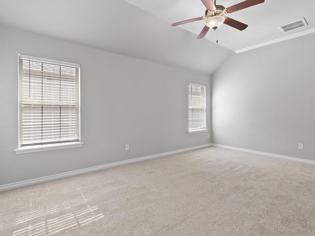 3325 NW 161st St, Edmond, OK 73013 - empty room with a ceiling fan, vaulted ceiling, carpet flooring, and healthy amount of natural light