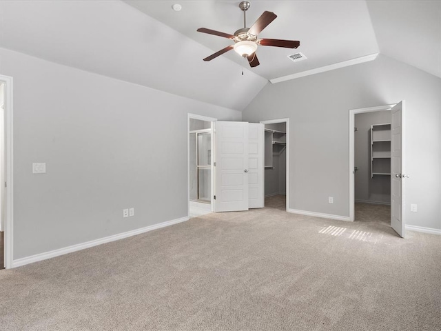 3325 NW 161st St, Edmond, OK 73013 - unfurnished bedroom with a walk in closet, vaulted ceiling, light carpet, ensuite bath, and a closet
