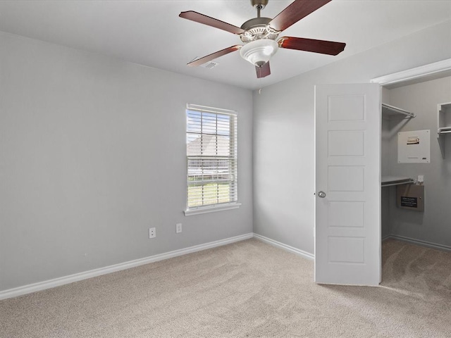 3325 NW 161st St, Edmond, OK 73013 - unfurnished bedroom featuring carpet flooring, a walk in closet, a closet, and a ceiling fan