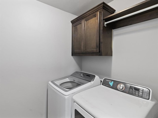 3325 NW 161st St, Edmond, OK 73013 - laundry area featuring cabinet space and washing machine and clothes dryer