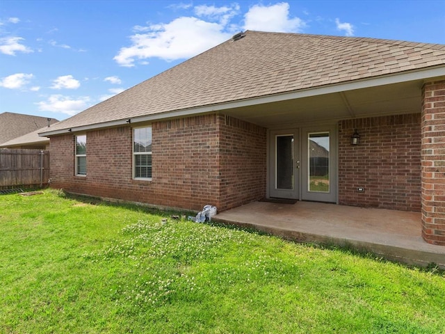 3325 NW 161st St, Edmond, OK 73013 - rear view of house featuring a shingled roof, brick siding, a patio, and french doors