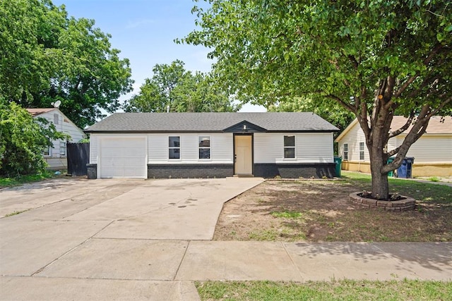 813 SW 56th St, Oklahoma City, OK 73109 - view of front of home featuring concrete driveway, a garage, and brick siding