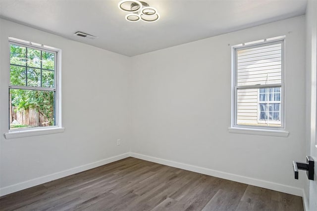 813 SW 56th St, Oklahoma City, OK 73109 - spare room with baseboards and dark wood-style flooring